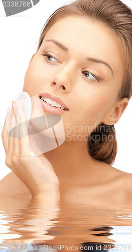 Image of beautiful woman with cotton pad