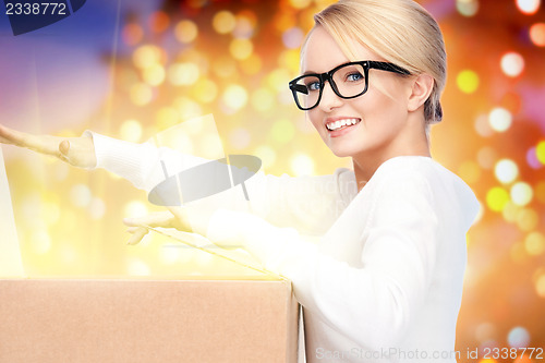 Image of attractive businesswoman with cardboard box