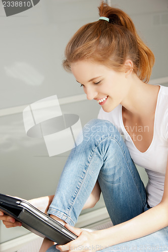 Image of happy teenage girl with tablet pc computer