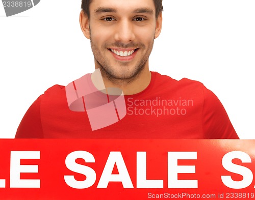 Image of handsome man with sale sign