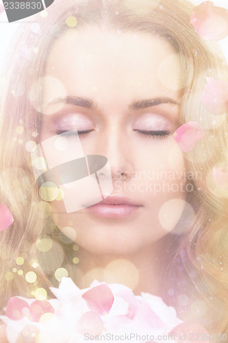 Image of beautiful woman with rose petals