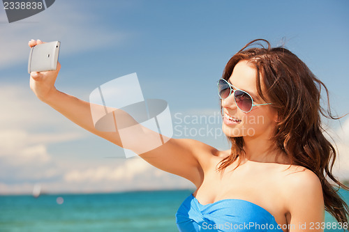 Image of happy smiling woman using phone camera