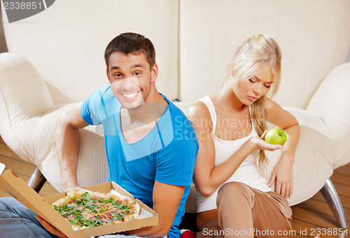 Image of couple eating different food