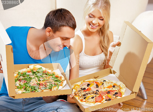 Image of romantic couple eating pizza at home