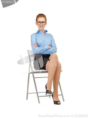 Image of happy and smiling woman on a chair