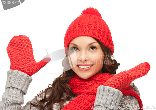 Image of beautiful woman in hat, muffler and mittens