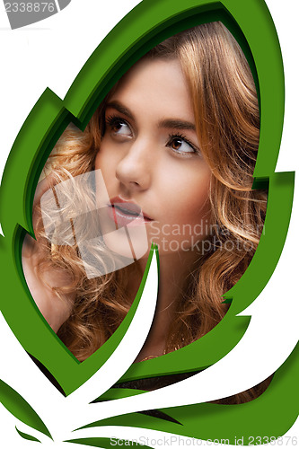 Image of woman looking through a leaf shape