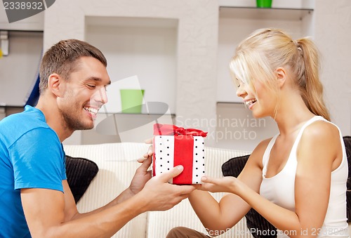 Image of happy romantic couple with gift