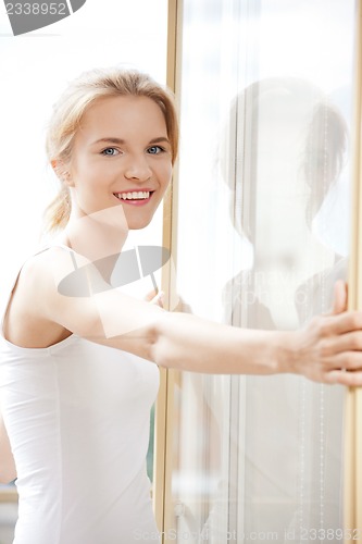 Image of happy teenage girl at the window