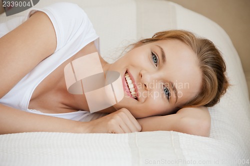 Image of smiling teenage girl on a bed