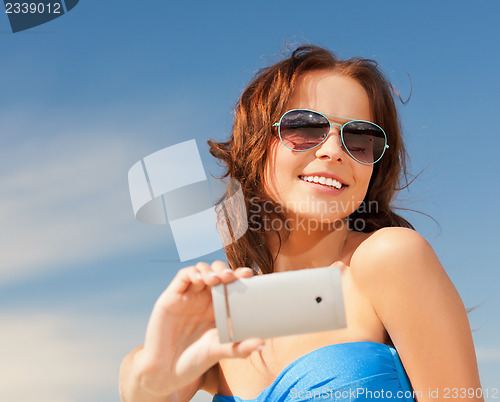 Image of happy smiling woman using phone camera