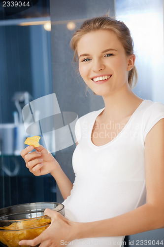 Image of happy and smiling teenage girl with chips