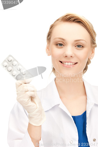 Image of attractive female doctor with pills