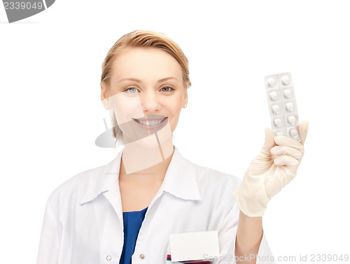 Image of attractive female doctor with pills