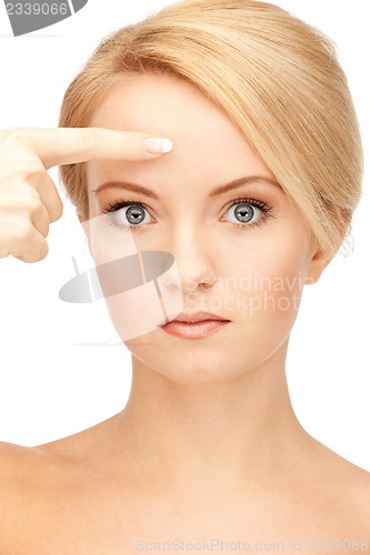 Image of beautiful woman pointing to forehead