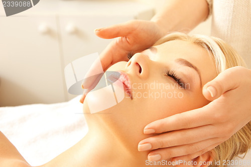 Image of beautiful woman in massage salon