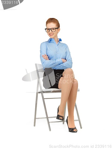 Image of happy and smiling woman on a chair