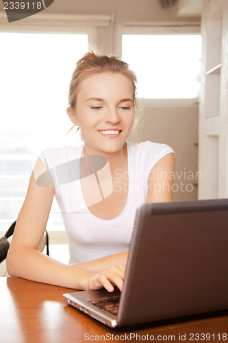 Image of happy teenage girl with laptop computer