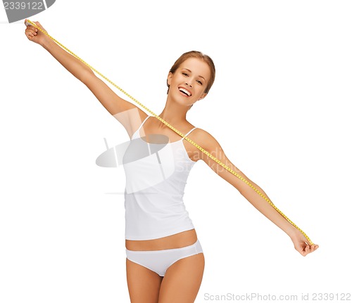 Image of young beautiful woman with measure tape
