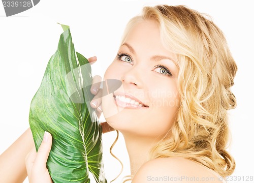 Image of woman with green leaf