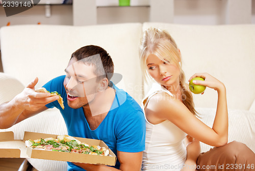Image of couple eating different food