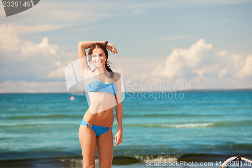 Image of happy smiling woman on the beach