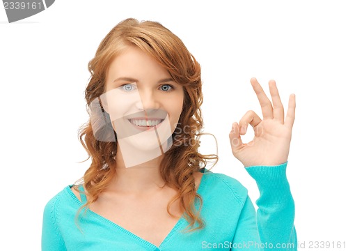 Image of teenage girl showing ok sign