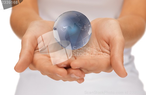 Image of woman hands holding earth globe