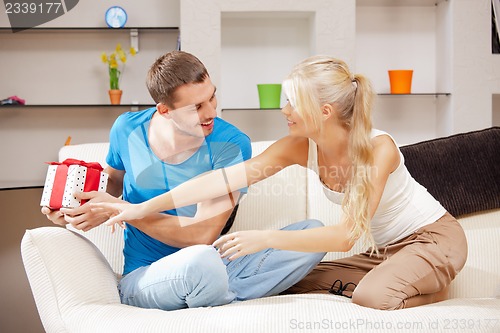 Image of happy romantic couple with gift