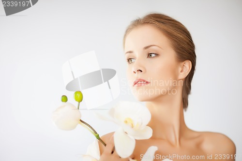 Image of lovely woman with orchid flower