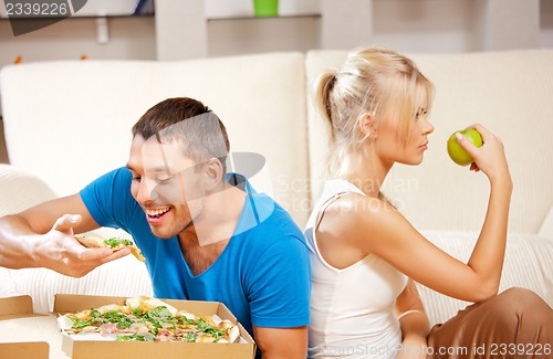 Image of couple eating different food