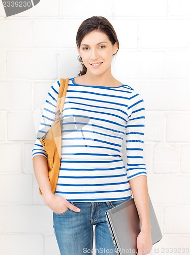 Image of happy and smiling teenage girl with laptop