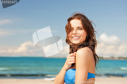 Image of happy smiling woman on the beach