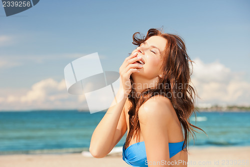 Image of laughing woman on the beach