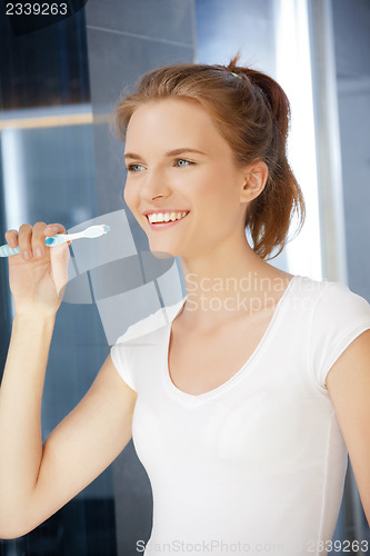 Image of smiling teenage girl with toothbrush