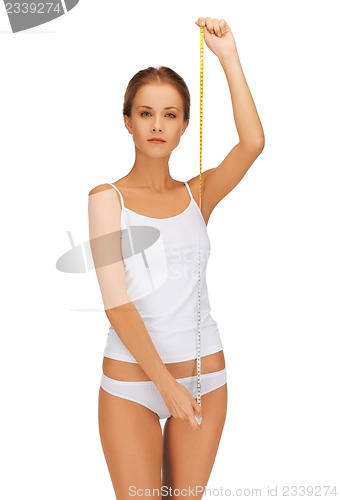 Image of young beautiful woman with measure tape