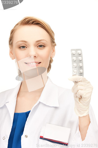 Image of attractive female doctor with pills