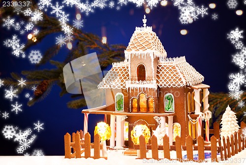 Image of gingerbread house over christmas background