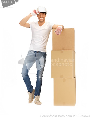 Image of handsome builder with big boxes