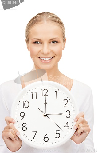 Image of woman holding big clock