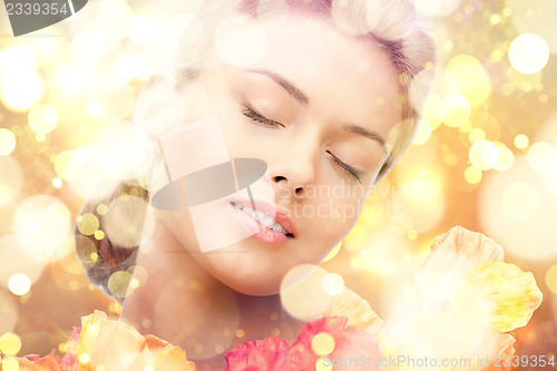 Image of lovely woman with red flowers