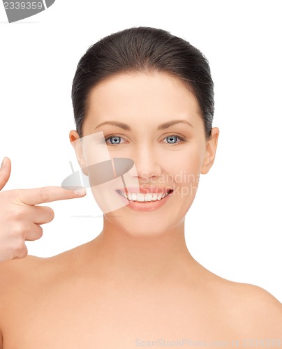 Image of beautiful woman pointing to teeth