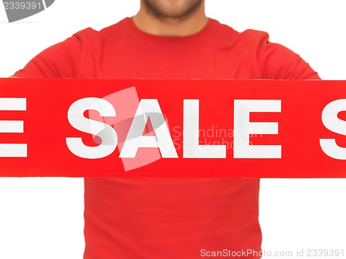 Image of man holding sale sign