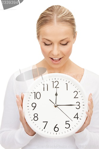 Image of woman holding big clock