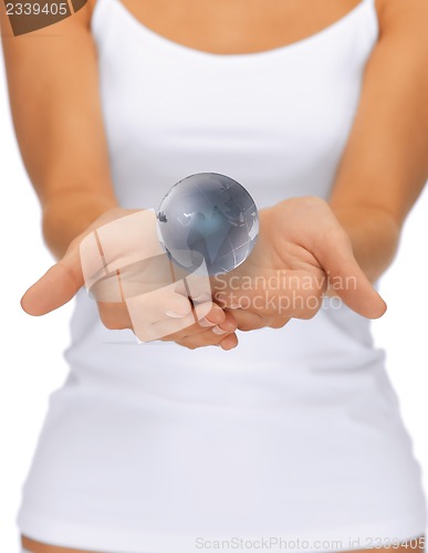 Image of woman hands holding earth globe