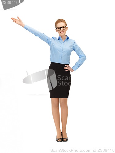 Image of attractive businesswoman pointing her hand