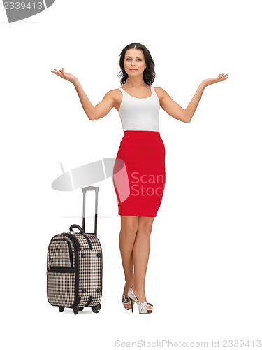 Image of happy woman with suitcase greeting