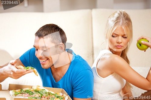 Image of couple eating different food