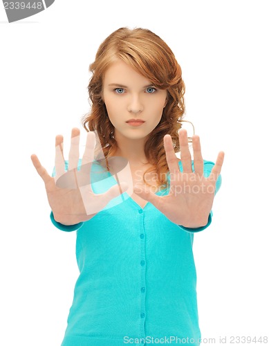 Image of young woman making stop gesture