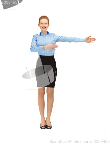 Image of smiling stewardess showing direction